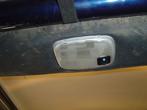 2002 Jeep Wrangler - Close-up of a vehicle's interior dome light with a blue illuminated switch.