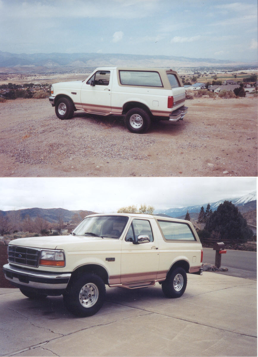 1995 Ford Bronco parked on a driveway with mountains in the background