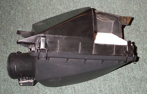 1998 Ford Crown Victoria - This is a black plastic air intake box with a white filter element visible inside.