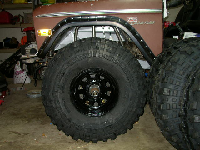 Ford Bronco fender with large off-road tire in foreground, another tire visible to the right