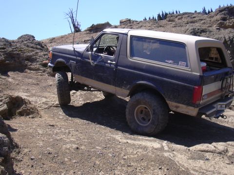 1991 Ford Bronco - Ford Bronco tackling rough terrain on a sunny day.