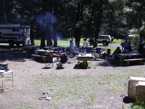 1991 Ford Bronco - A group of people are gathered at a campsite with a Bronco and an RV.