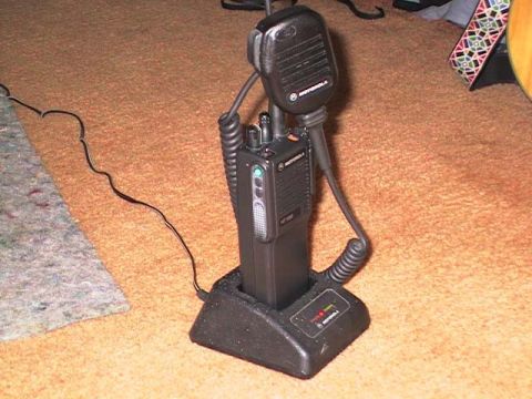2000 Jeep Liberty - A Motorola HT1000 radio and microphone are shown in their charging base on a carpeted floor.