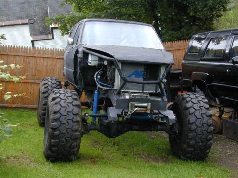 1985 Ford Bronco - This heavily modified vehicle is undergoing a custom build, oversized tires and a reinforced front end.