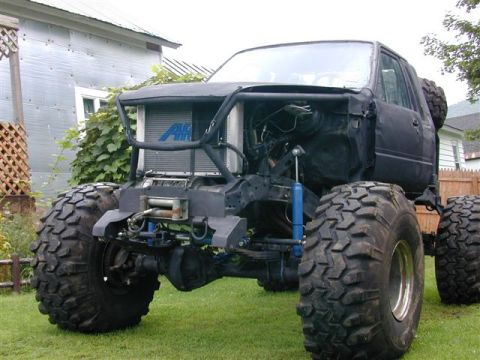 1985 Ford Bronco - This heavily modified truck features massive tires and a custom front bumper with a winch.