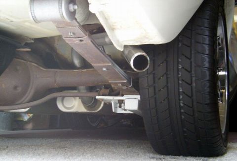 1978 Ford Mustang II - Undercarriage view showing the rear axle, leaf spring, and exhaust system of a vehicle.