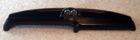 1978 Ford Mustang II - A black dashboard assembly with two gauges is shown against a carpeted background.