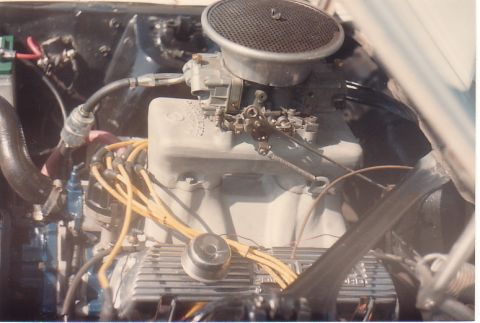 1968 Ford Mustang - Engine bay detail with carburetor and yellow spark plug wires visible.