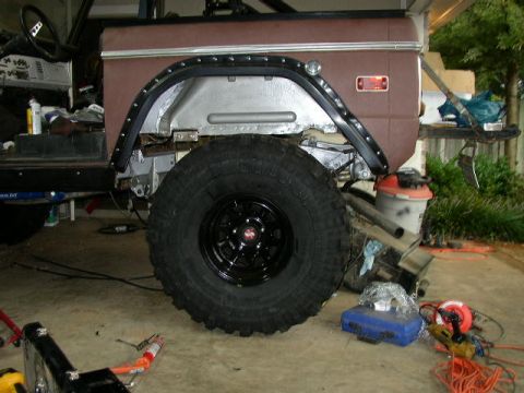 1995 Ford Bronco - This vehicle's side view shows a brown fender and a large tire, indicating it is likely a 1978 model undergoing restoration.