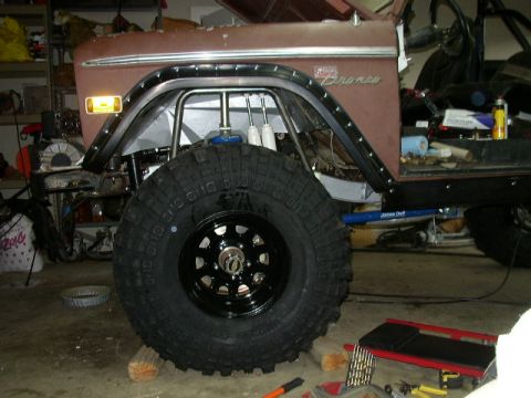 1995 Ford Bronco - Modified Ford Bronco fender and tire, indicating custom off-road build.