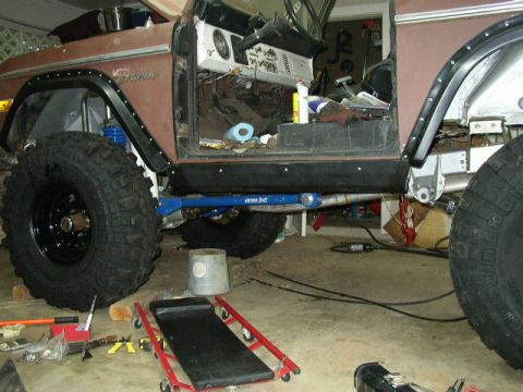 1995 Ford Bronco - This modified Ford Bronco is undergoing repairs or upgrades in a garage setting.