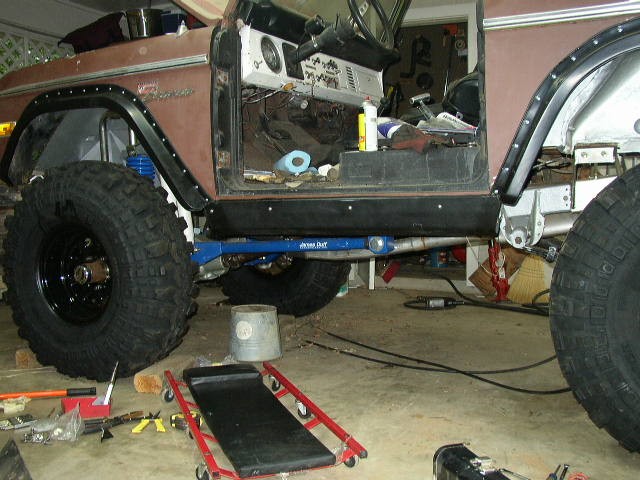 Ford Bronco with large tires and suspension modifications, interior visible