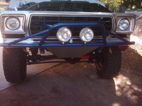 1978 Ford Bronco - Front view of a 1978 Ford Bronco, modified with a blue bull bar and auxiliary lights.