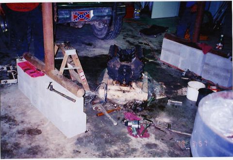 1984 Ford Bronco - Engine block removed from vehicle, surrounded by tools and shop debris.