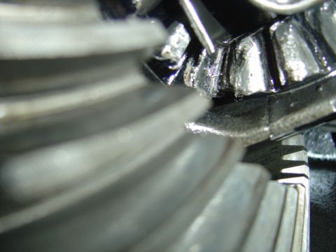 1996 Ford Bronco - Close-up view of worn differential gears, showing lubricant and metal shavings.
