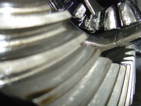 1996 Ford Bronco - Close-up view of differential gears showing signs of wear and metal debris, indicating potential mechanical issues.