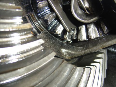 1996 Ford Bronco - Damaged differential gears shown with a tool, likely from a vehicle repair.