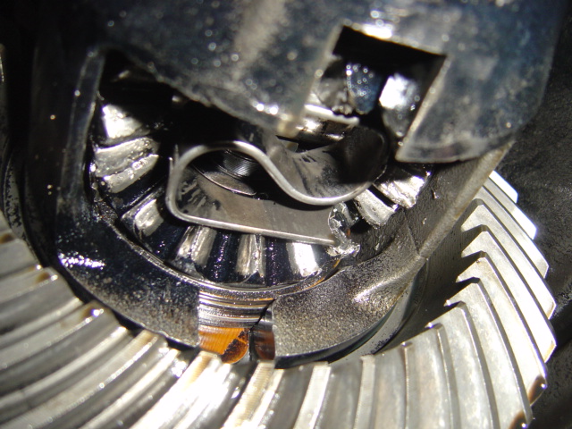 Close-up of damaged differential gears with metal shavings