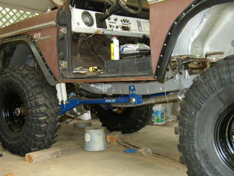 1995 Ford Bronco - The interior and suspension of a 1974 Ford Bronco are shown, with visible rust on the exterior panels.