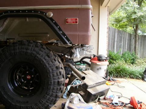 1995 Ford Bronco - Side view of a 1978 Ford Bronco with a large tire and detached fuel tank.