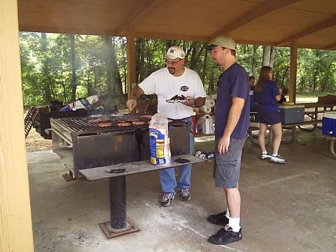 1989 Ford Bronco - A group enjoys a cookout with burgers on the grill at a park pavilion.