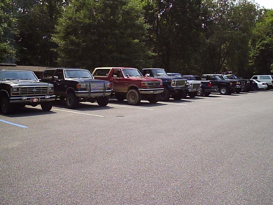 1989 Ford Bronco and other trucks parked in a lot