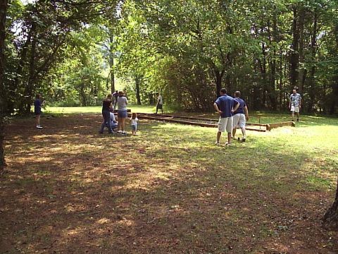 1989 Ford Bronco - A group of people enjoy a cookout in a park setting on a sunny day.