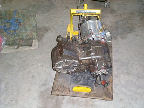 1994 Ford Bronco - Transmission and transfer case assembly on a pallet, likely for repair or replacement.