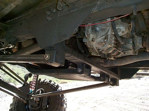 1994 Ford Bronco - Close-up of the undercarriage, focusing on suspension and drivetrain parts of a custom vehicle.