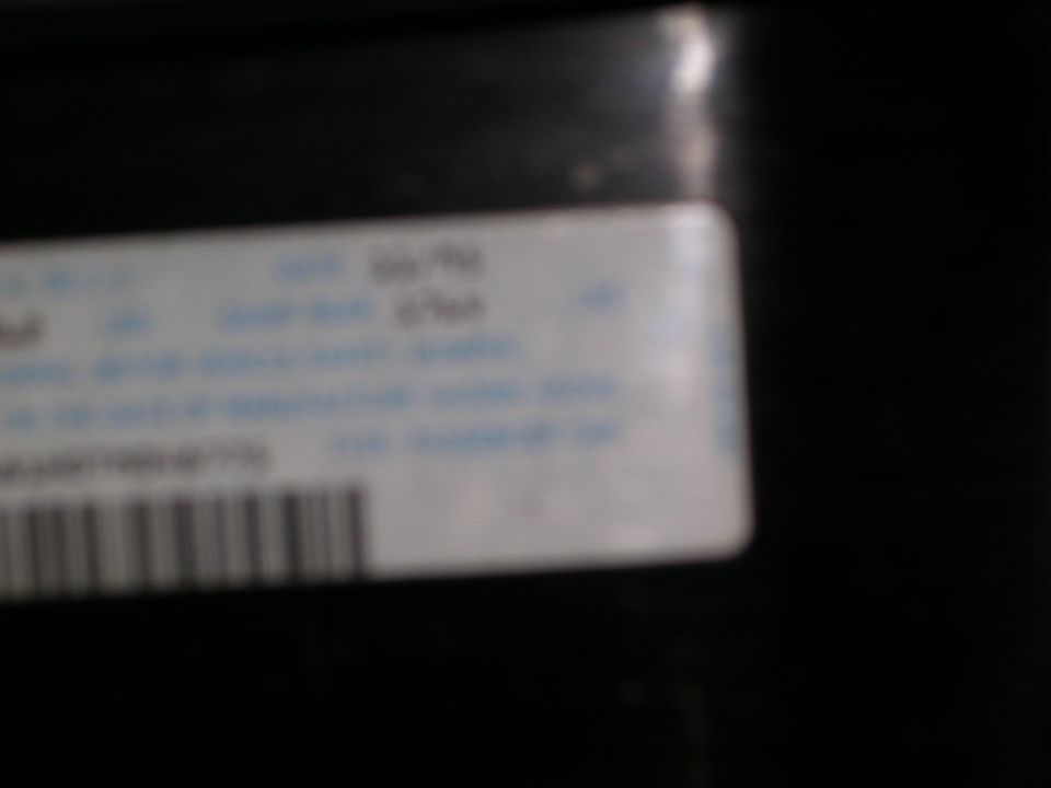 Close-up of a sticker with text and a barcode