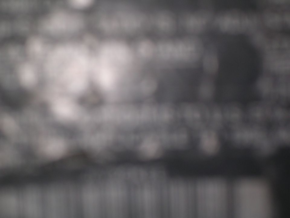 Blurred document with text and a watermark reading SUPERMOTORS