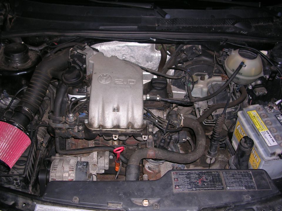 Volkswagen 2.0 engine bay with red air filter and battery