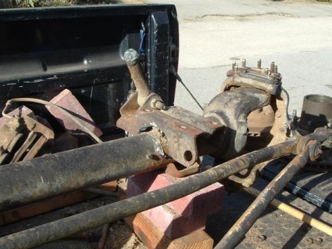 1989 Ford Bronco - grinding and beating off the old trac bar mount.