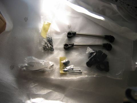 1985 Ford Crown Victoria LTD - A collection of automotive parts, including rods and fasteners, are neatly packaged in plastic wrap.