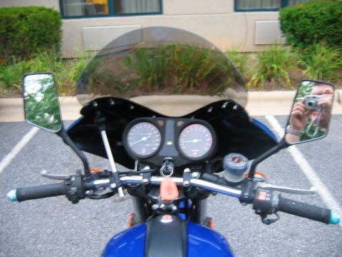 1985 Ford Crown Victoria LTD - View from the rider's perspective of a motorcycle's handlebars, gauges, and windshield.
