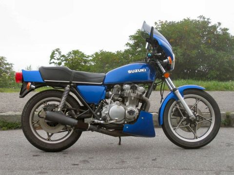 1985 Ford Crown Victoria LTD - This blue Suzuki motorcycle has a small windscreen and a prominent engine.