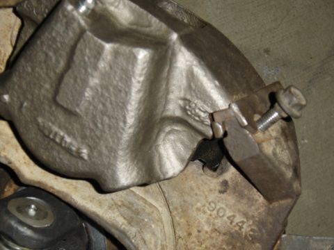 1988 Ford Bronco - Close-up of a brake caliper, showing the part number 9044 stamped into the metal. The registry information may be incorrect.