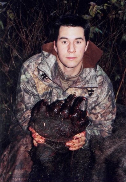 1993 Ford Bronco - Hunter displays a bear paw after a hunt, with a Supermotors.net logo visible.