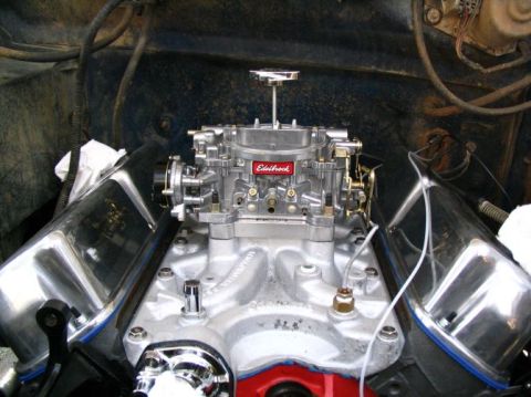 1984 Ford Bronco - Close-up of an engine bay, focusing on the carburetor and valve covers.