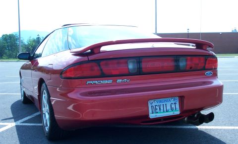 1996 Ford Probe - Rear view of a red 1996 Ford Probe GT, a spoiler and dual exhaust pipes.
