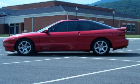 1996 Ford Probe - Side profile of a red 1996 Ford Probe GT in a parking lot.