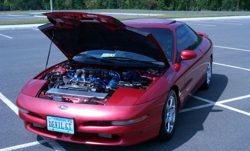Red Ford Probe coupe with hood up showing engine, blue plug wires, Virginia DEVIL GT plate