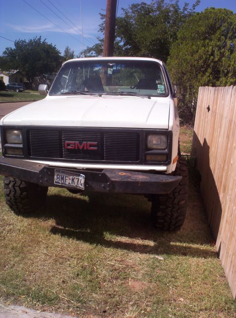1988 Ford Bronco - Front view of a white GMC pickup truck, possibly from the early 1980s, with a custom bumper.