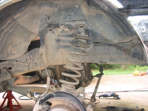 1988 Ford Bronco - Front suspension components of a 1988 Ford Bronco undergoing work.