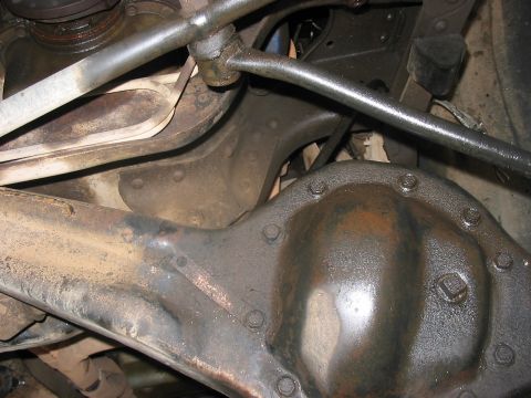 1988 Ford Bronco - Underside view of a vehicle's differential and suspension parts, showing signs of wear and rust.