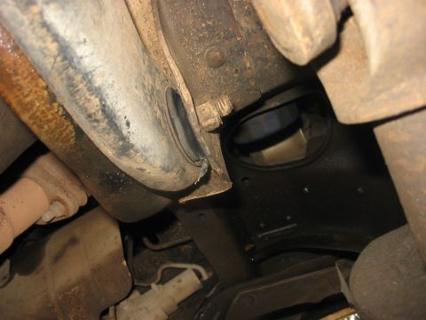 1988 Ford Bronco - Close-up view of the vehicle's undercarriage, showing suspension and exhaust system components.