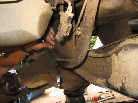 1988 Ford Bronco - Close-up of a vehicle's rear axle and suspension components during a repair or installation.