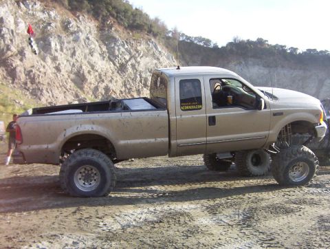 2000 Ford F-450 - This lifted 2000 Ford F-450 pickup truck is shown in a side profile, ready for off-road adventures.