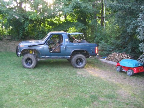1986 Ford Bronco - This modified SUV has large tires and a roll cage, suggesting it's built for off-road use.