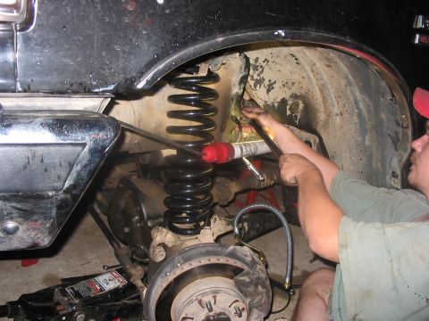 1988 Ford Bronco - Working on the rear suspension of a 1988 Ford Bronco, focusing on the coil spring and shock.